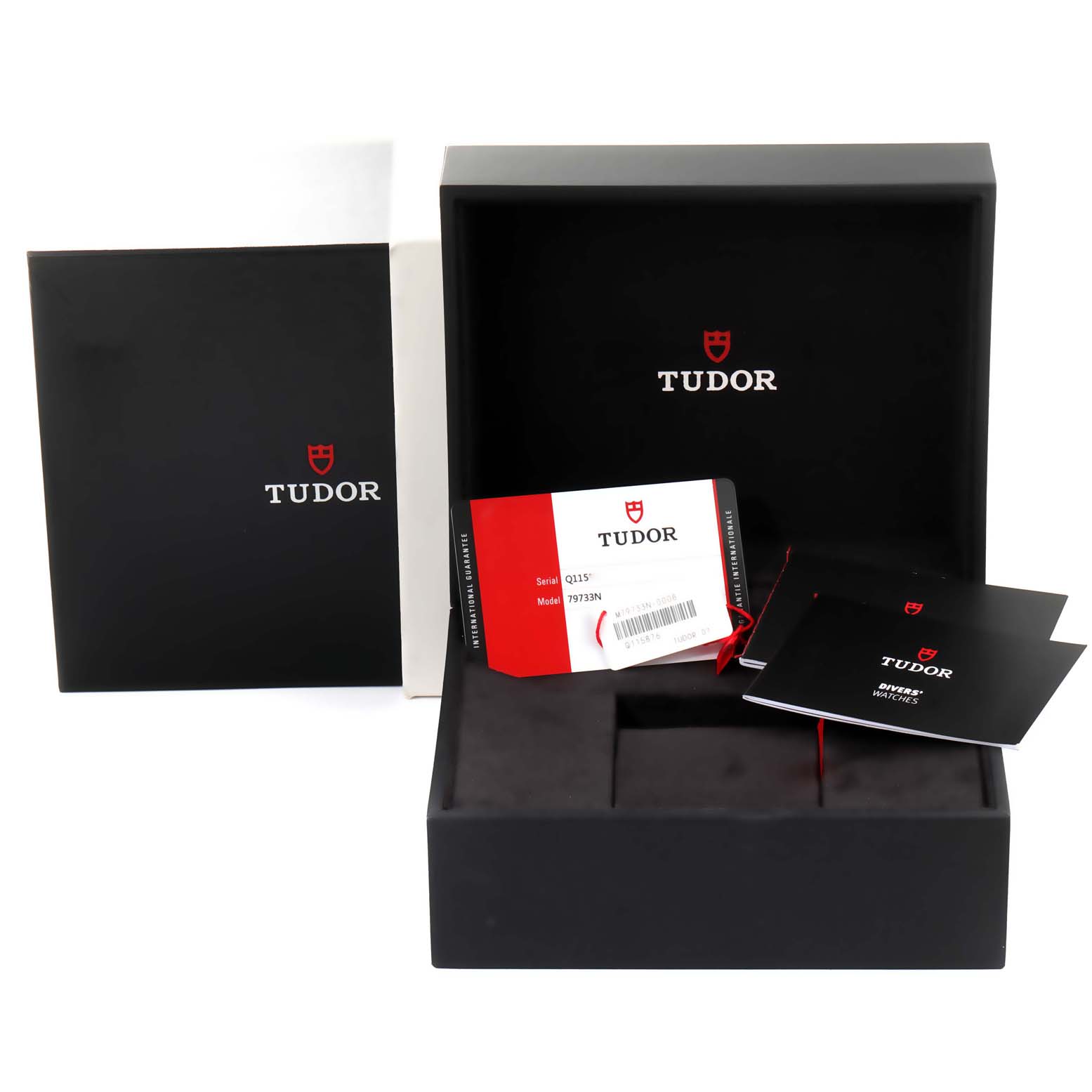 The image shows packaging, documentation, and guarantee card for the Tudor Heritage Black Bay 79733 Men's Steel and Gold (two tone) Black Dial 79733 Men's Steel and Gold (two tone) Black Dial watch, but not the watch itself.
