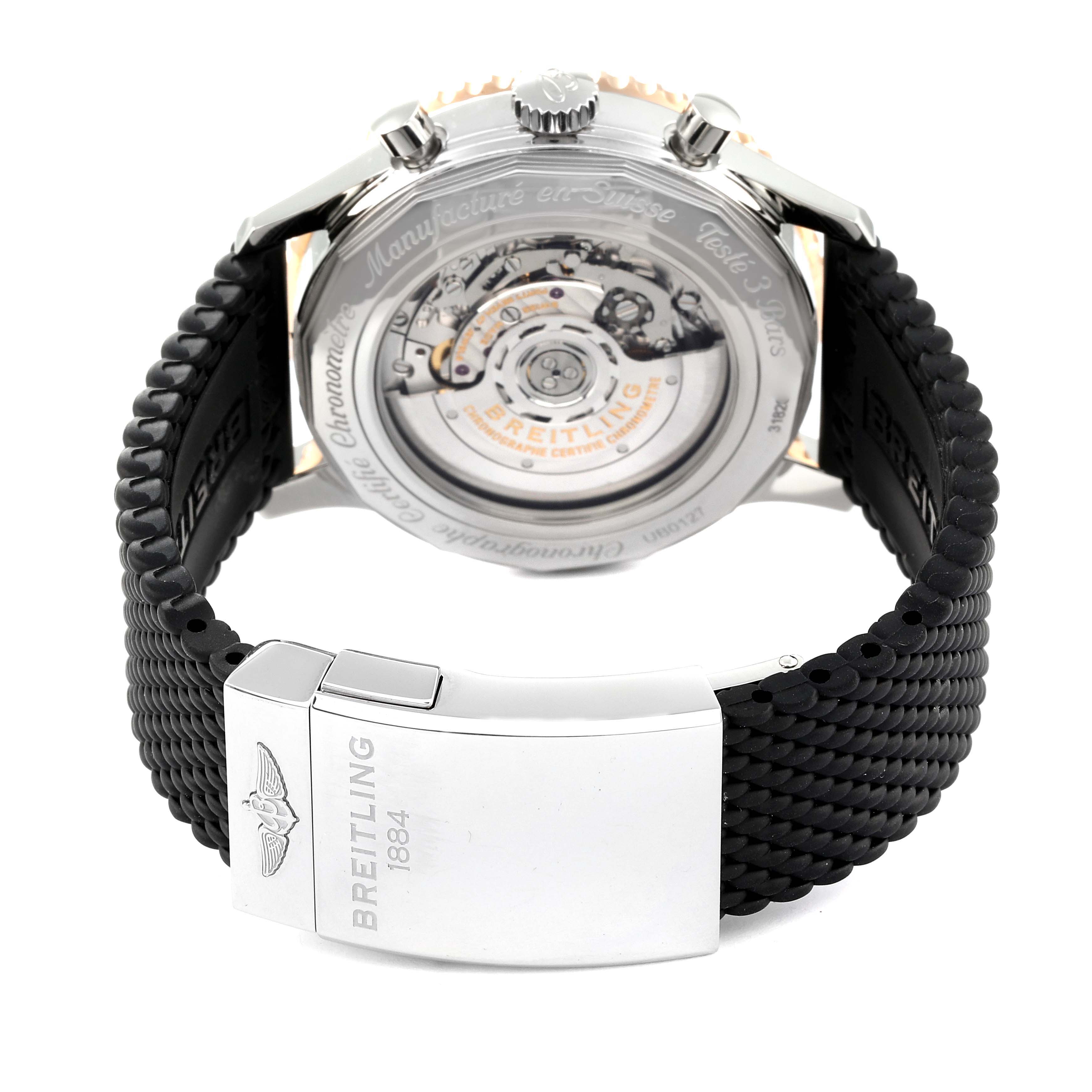 This image shows the back view of a Breitling Navitimer UB0127 Men's Steel and Gold (two tone) Black Dial UB0127 Men's Steel and Gold (two tone) Black Dial watch, highlighting its movement and black strap clasp.