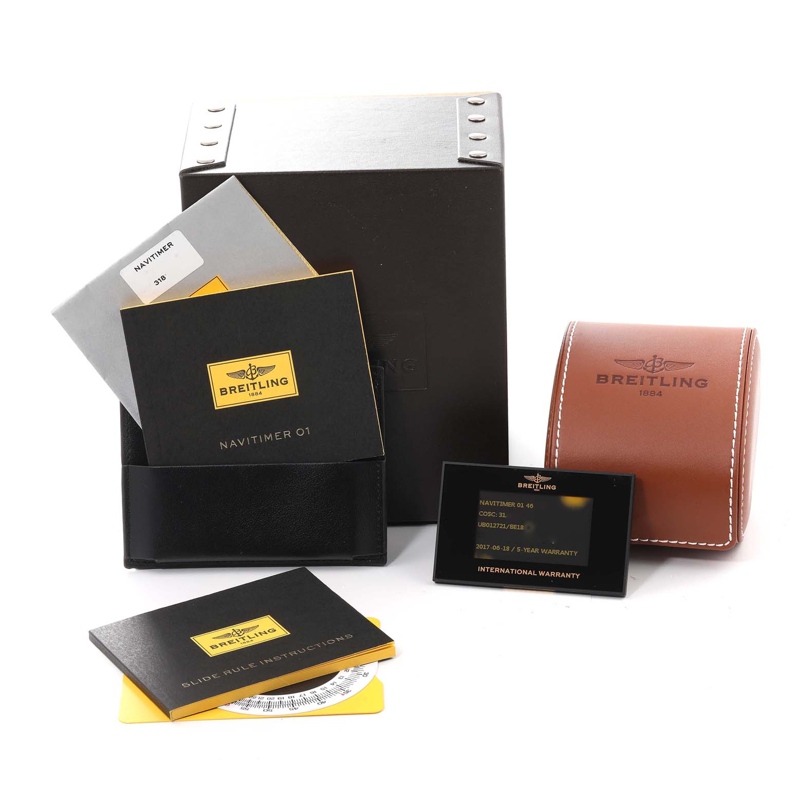 The image shows accessories for the Breitling Navitimer UB0127 Men's Steel and Gold (two tone) Black Dial UB0127 Men's Steel and Gold (two tone) Black Dial model, including manuals, a case, warranty card, and a leather pouch.