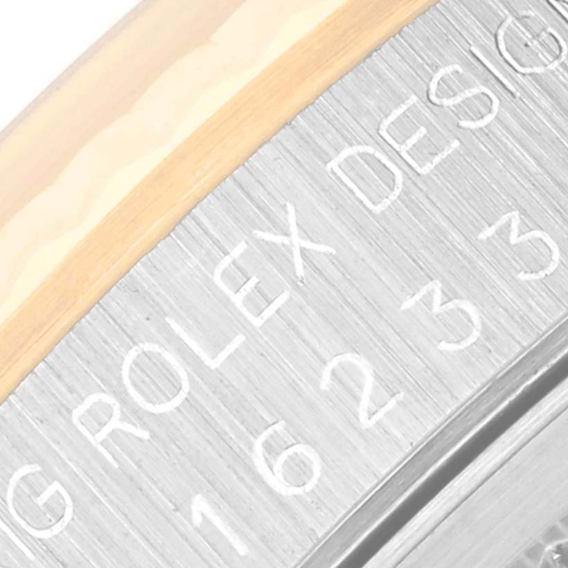 This is a close-up of the side of a Rolex Datejust 16233 Men's Steel and Gold (two tone) Champagne Dial 16233 Men's Steel and Gold (two tone) Champagne Dial watch, showing engraved text and model details.