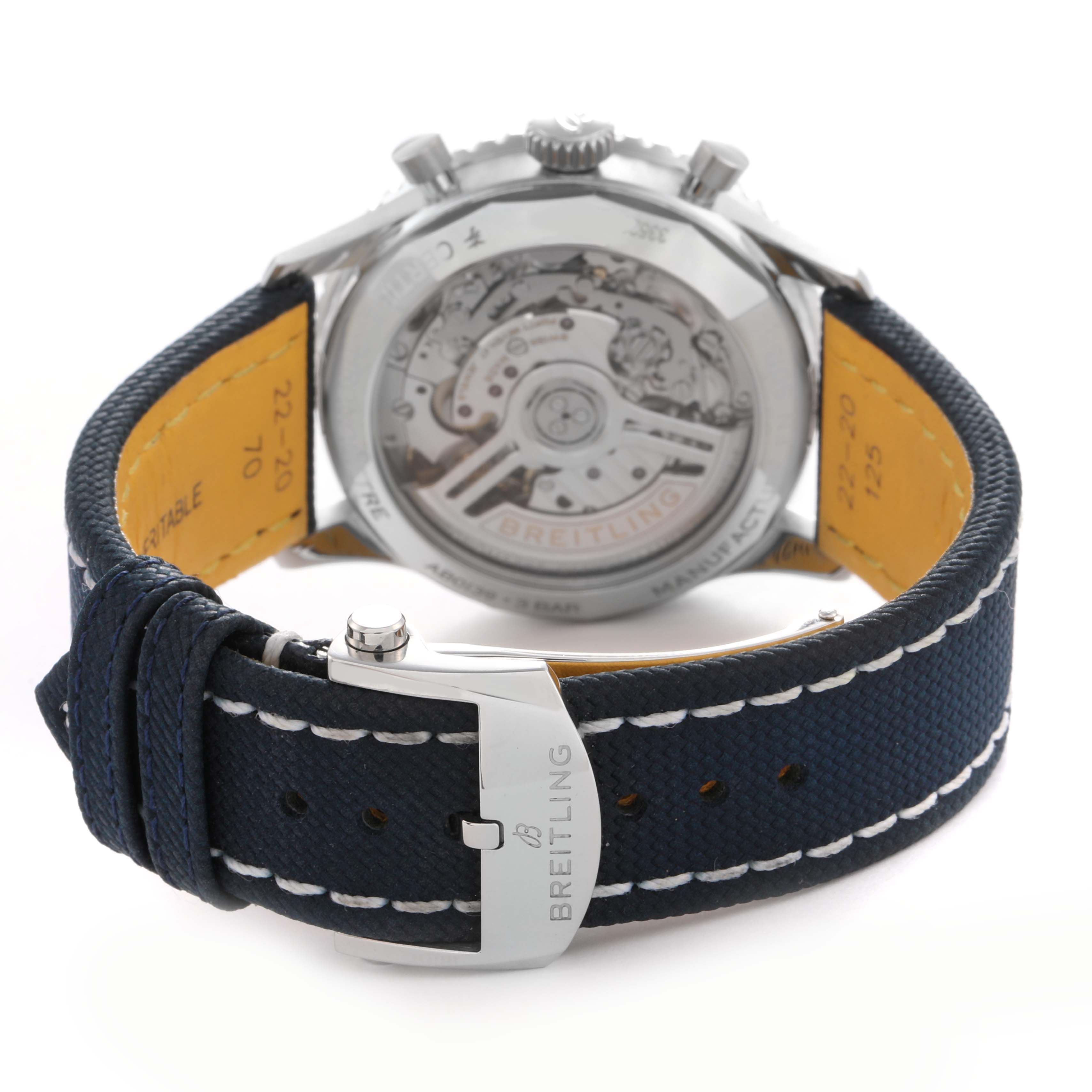 The image shows a Breitling Navitimer AB0139241C1P1 men's watch from the back, highlighting the open case back and buckle with branding.