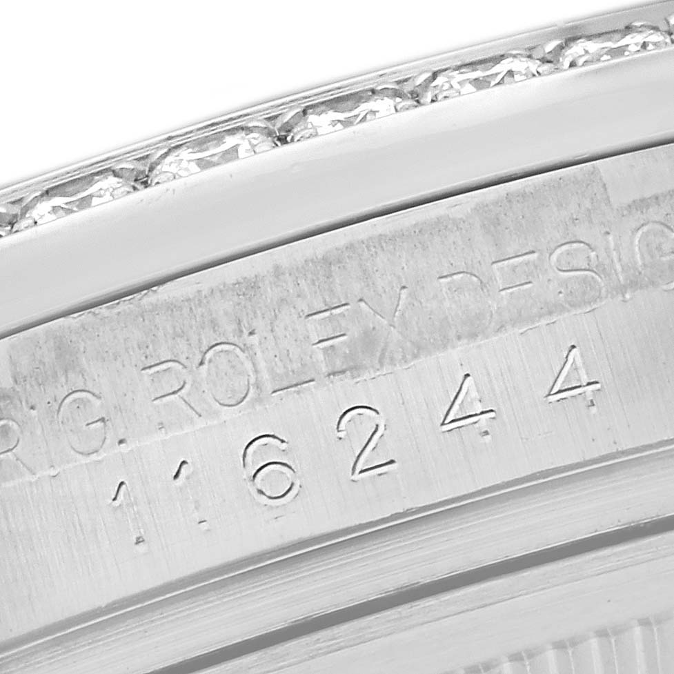 The image shows a close-up of the side of a Rolex Datejust 116244 Men's Stainless Steel Silver Dial 116244 Men's Stainless Steel Silver Dial watch, focusing on the engraved serial number and part of the bezel.