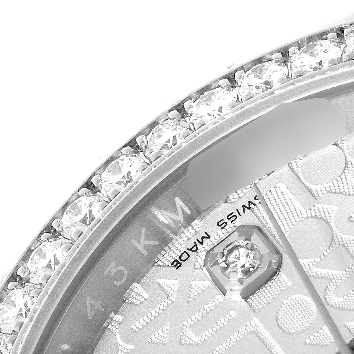 This close-up image of the Rolex Datejust 116244 Men's Stainless Steel Silver Dial 116244 Men's Stainless Steel Silver Dial watch features the diamond-studded bezel and a portion of the dial text.