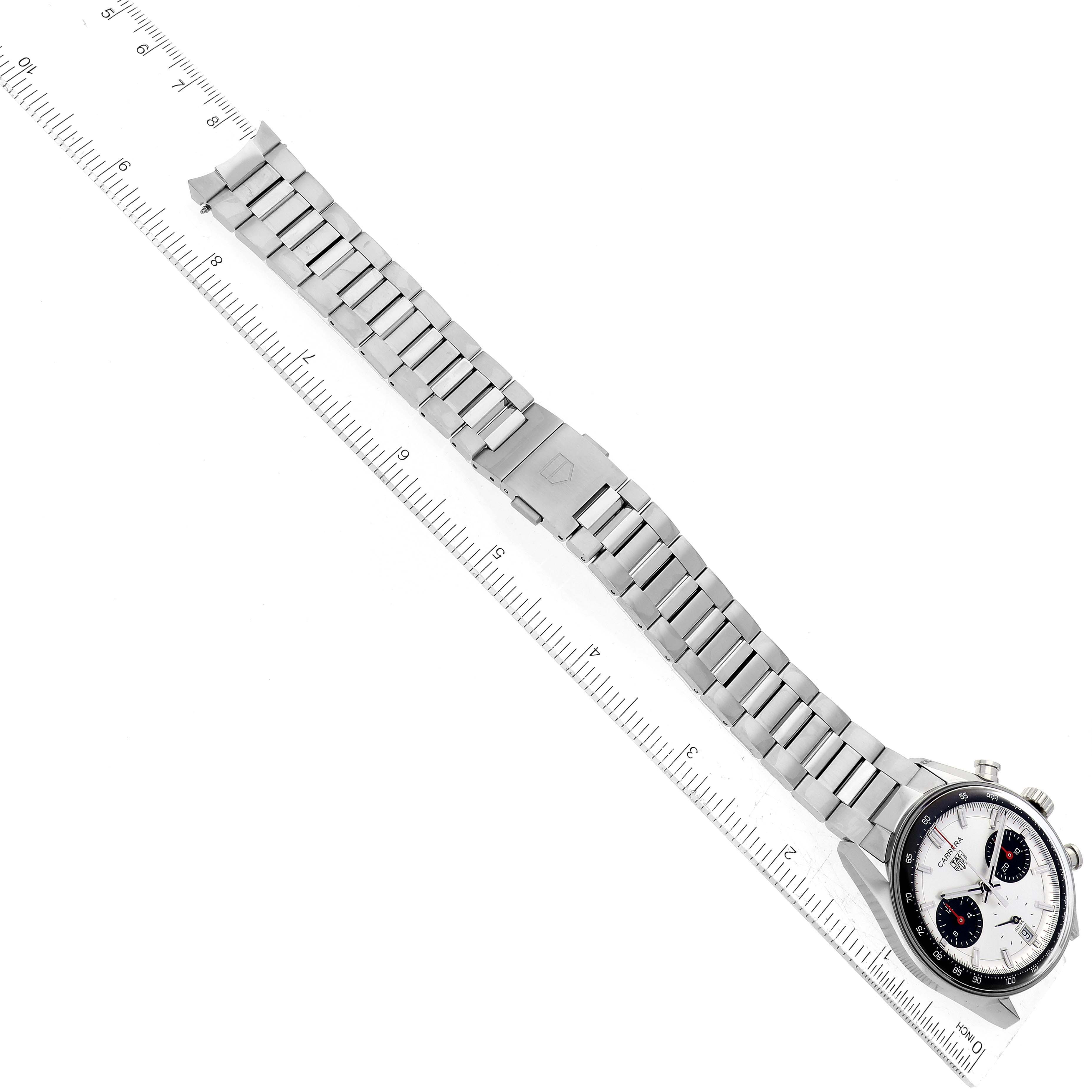 The image shows a top view of a Tag Heuer Carrera CBS2216 Men's Stainless Steel Silver Dial CBS2216 Men's Stainless Steel Silver Dial watch, including its stainless steel bracelet and clasp, next to a ruler for scale.