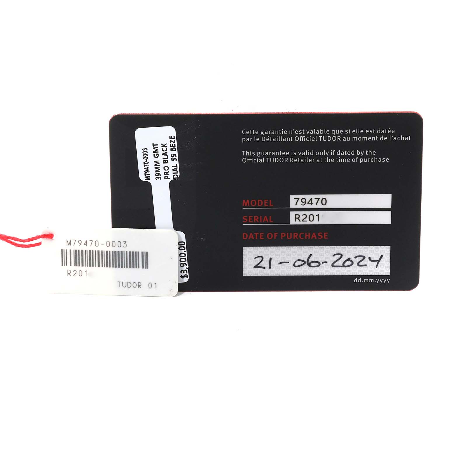 This image shows the warranty and price tags for a Tudor Heritage Black Bay 79470 Men's Stainless Steel Black Dial 79470 Men's Stainless Steel Black Dial model 79470 watch, displaying the serial number and purchase date.