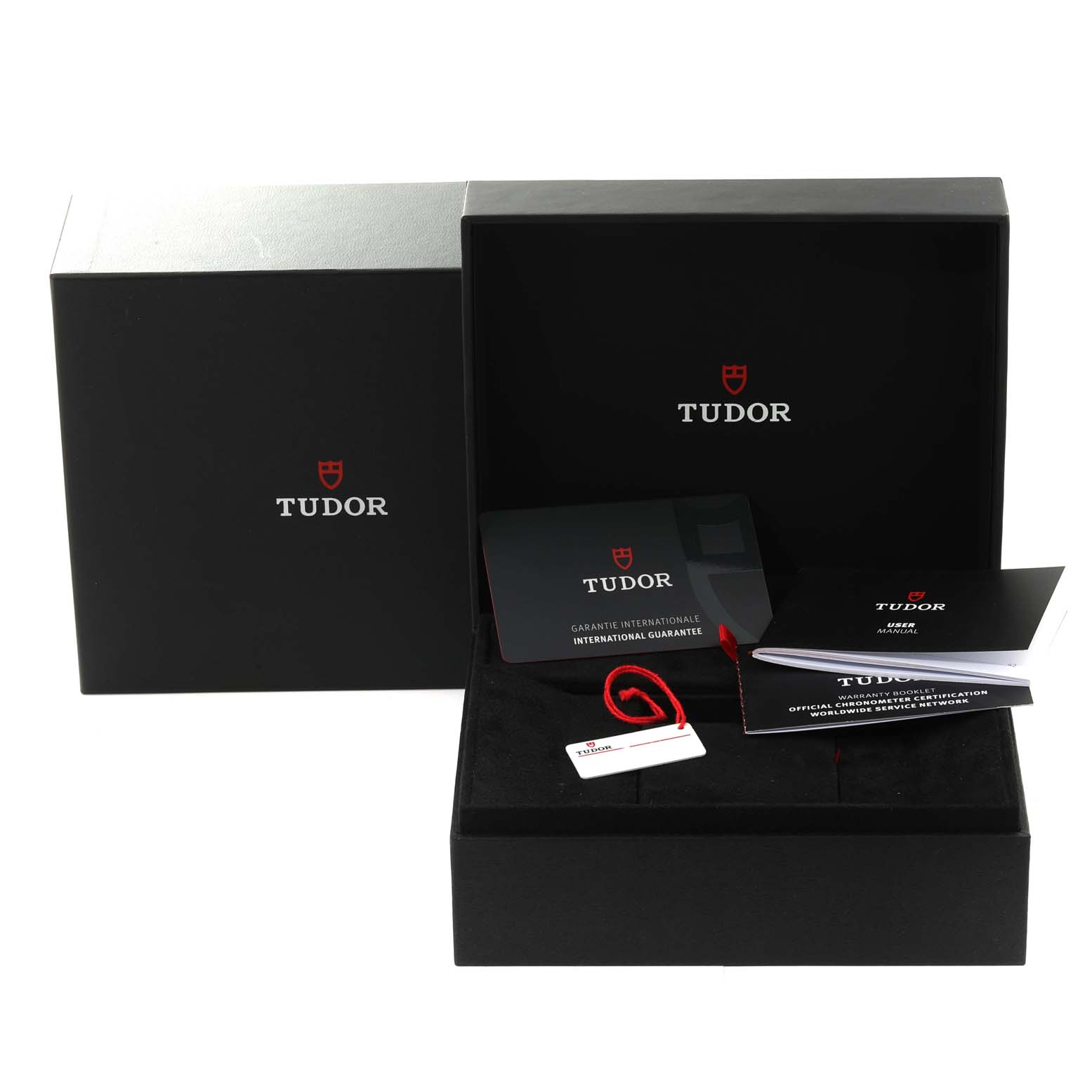 The image shows a Tudor Heritage Black Bay 79470 Men's Stainless Steel Black Dial 79470 Men's Stainless Steel Black Dial watch box at an angle, along with the international guarantee card, booklet, and tags.