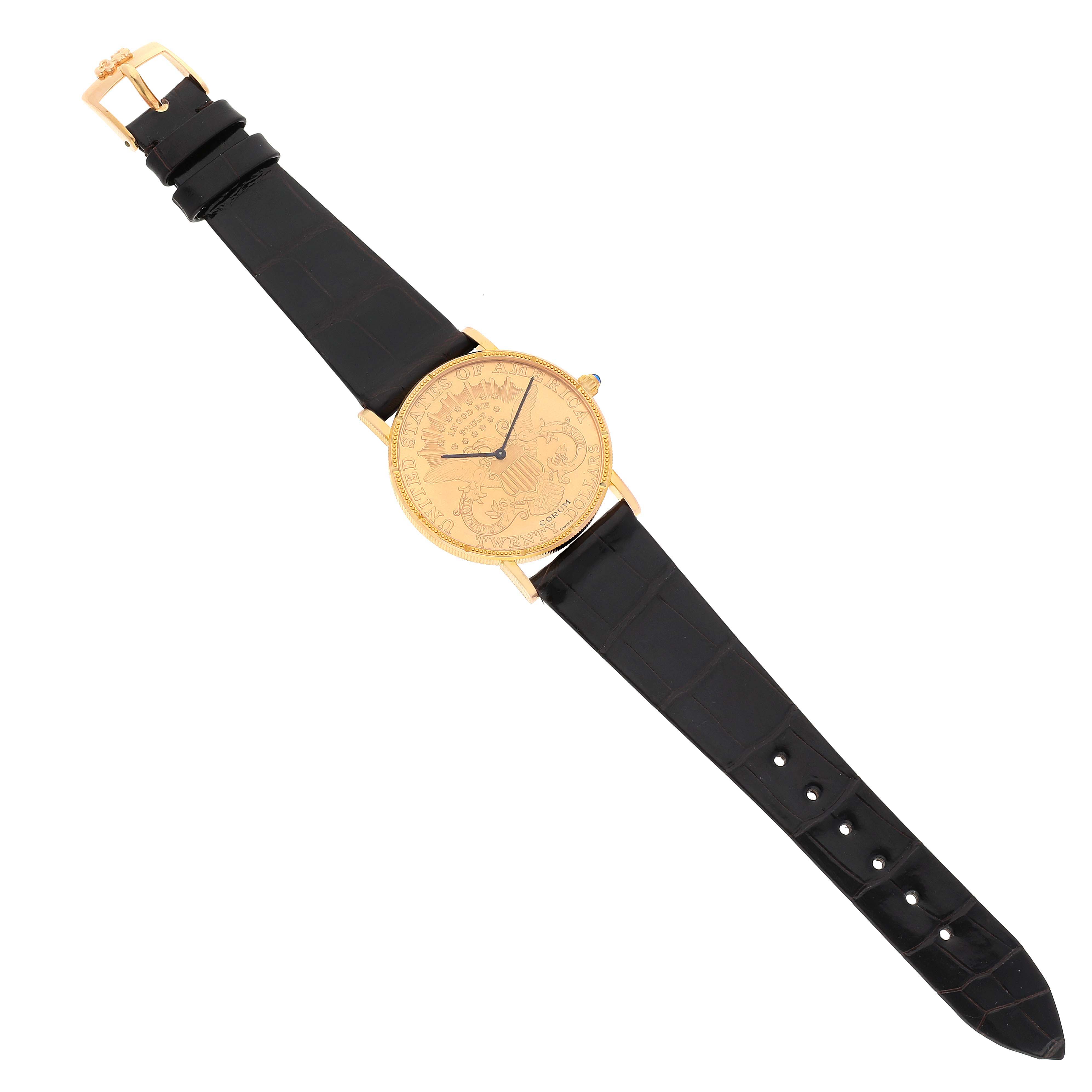 The image shows a Corum Coin Watch Men's Yellow Gold Black Dial Men's Yellow Gold Black Dial model with a black leather strap, viewed from above showcasing its full face and band.