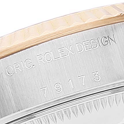 This is a close-up view of the case side of a Rolex Datejust 79173 Women's Steel and Gold (two tone) White Dial 79173 Women's Steel and Gold (two tone) White Dial watch, showing the engraving "ORIG. ROLEX DESIGN" and model number "79173."