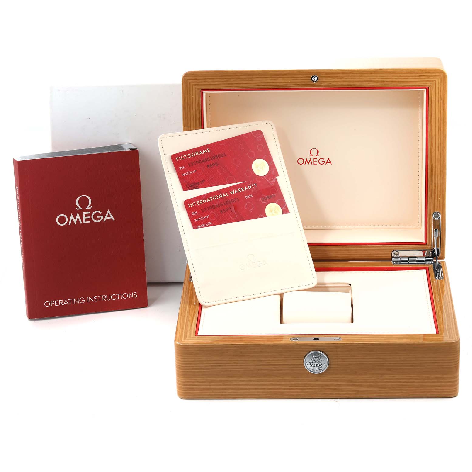 This image shows the accessories for an Omega Planet Ocean 232.90.46.51.03.001 Men's Titanium Blue Dial 232.90.46.51.03.001 Men's Titanium Blue Dial watch, including a wooden box, warranty cards, and an operating instructions booklet.