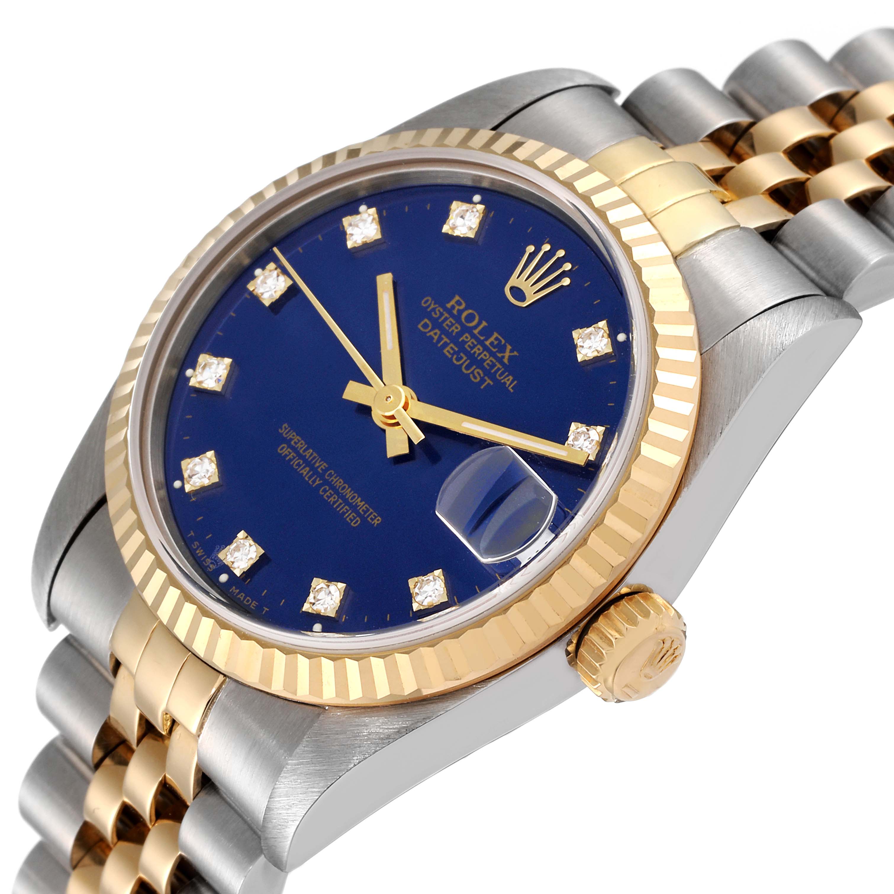 This image showcases a Rolex Mid-Size 68273 Women's Steel and Gold (two tone) Blue Dial 68273 Women's Steel and Gold (two tone) Blue Dial Datejust watch at an angle, highlighting the bezel, crown, blue dial, and part of the bracelet.