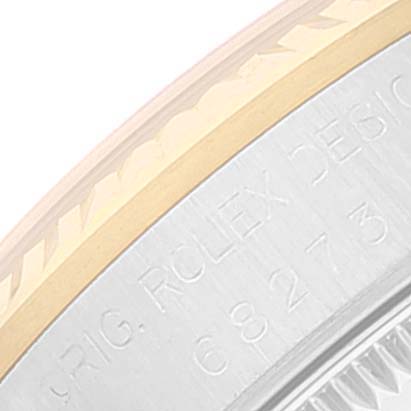 This close-up shows the side view of the casing and bezel of a Rolex Mid-Size 68273 Women's Steel and Gold (two tone) Blue Dial 68273 Women's Steel and Gold (two tone) Blue Dial model watch, highlighting engraved text.