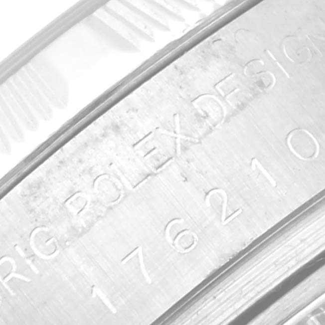 The image shows a close-up view of the engraved serial number and design details on the metal casing of a Rolex Oyster Perpetual 176210 Women's Stainless Steel Silver Dial 176210 Women's Stainless Steel Silver Dial watch.