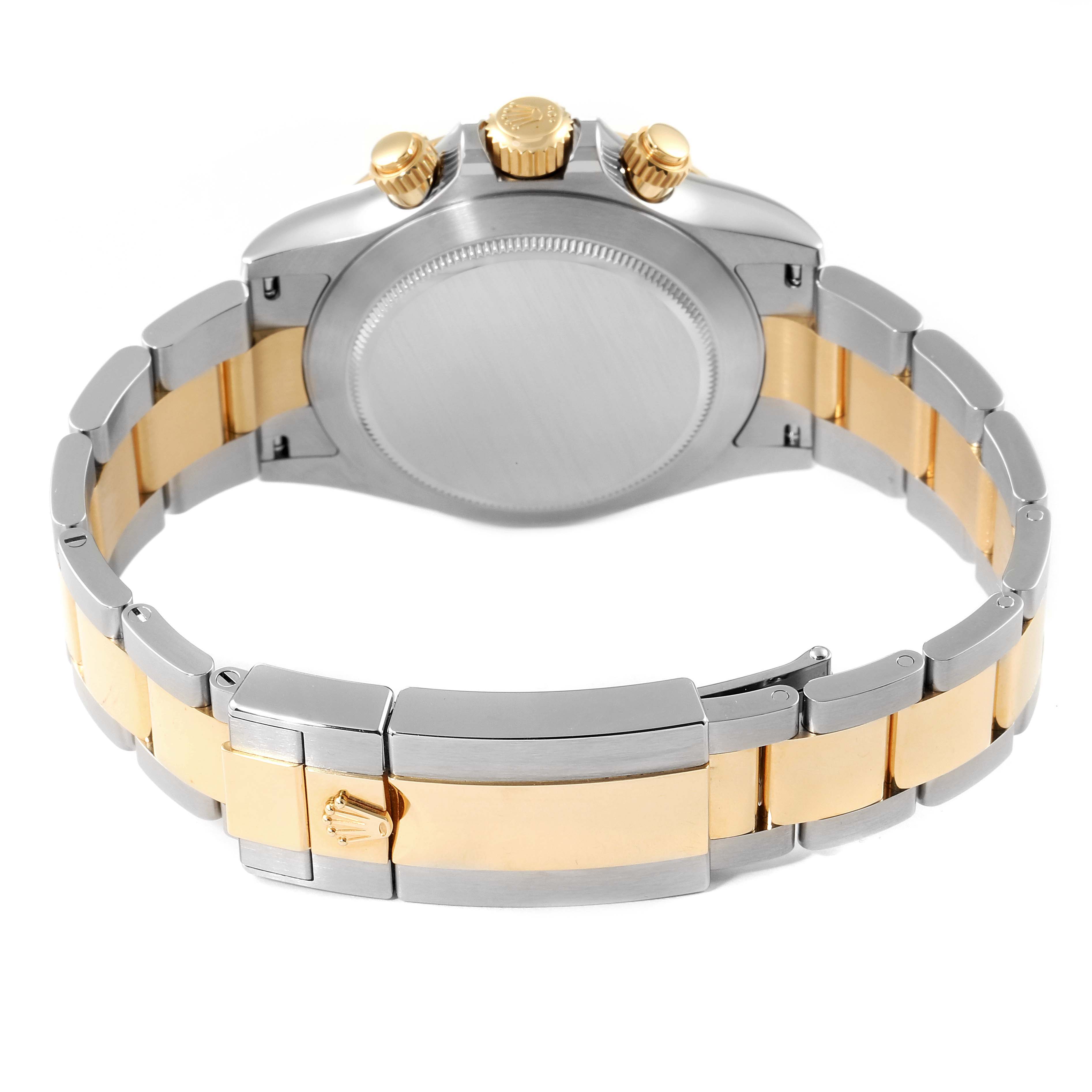 The image shows the back view of a Rolex Daytona 116503 Men's Steel and Gold (two tone) Champagne Dial 116503 Men's Steel and Gold (two tone) Champagne Dial watch, highlighting its clasp, bracelet, and three gold pushers/crown.