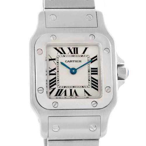 The image shows a close-up front view of the dial, bezel, and part of the bracelet of the Santos by Cartier watch.