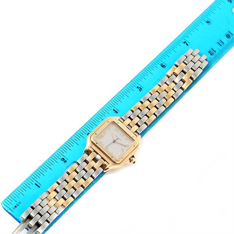 The image shows a Cartier Panthère watch laid out flat with a blue ruler measuring the length of its two-tone bracelet.