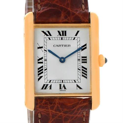 This image shows a Cartier Tank Classic Men's Yellow Gold White Dial Men's Yellow Gold White Dial watch from a front angle, highlighting its dial, Roman numerals, gold case, and brown leather strap.