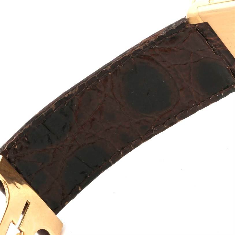 This image shows a close-up angle of the leather strap and metal clasp of a Tank Classic watch by Cartier.