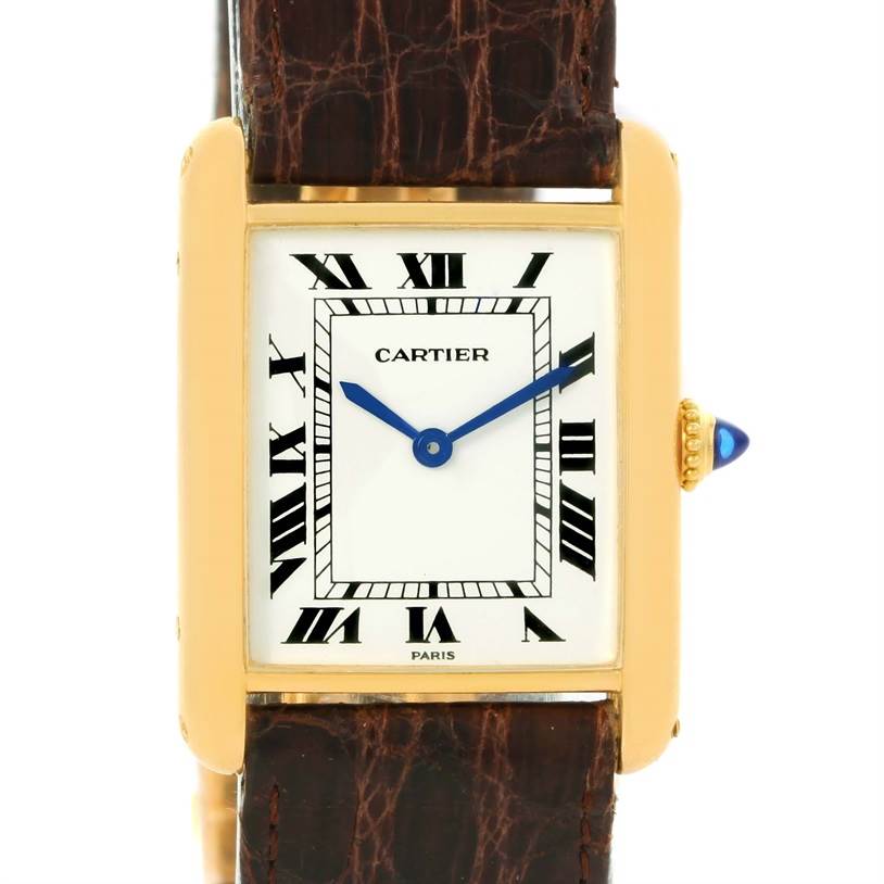 The image shows a front view of the Cartier Tank Classic Men's Yellow Gold White Dial Men's Yellow Gold White Dial watch with its rectangular dial, Roman numerals, and leather strap.