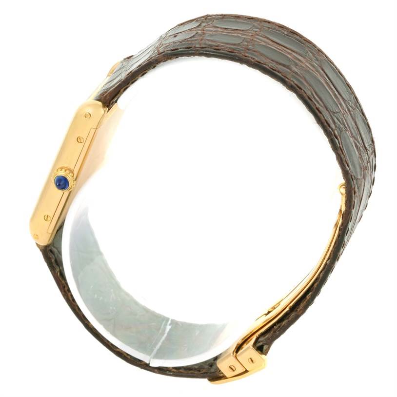 This image shows a side view of the Cartier Tank Classic Men's Yellow Gold White Dial Men's Yellow Gold White Dial watch, highlighting the crown and part of the strap.