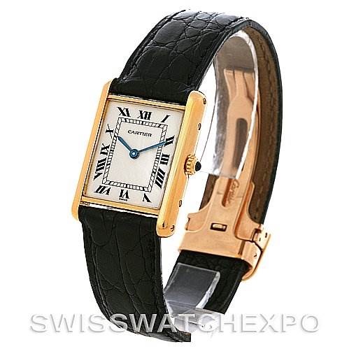 The image shows a Cartier Tank Classic Yellow Gold White Dial Yellow Gold White Dial watch viewed at an angle highlighting its black leather strap, rectangular gold case, and Roman numeral dial.