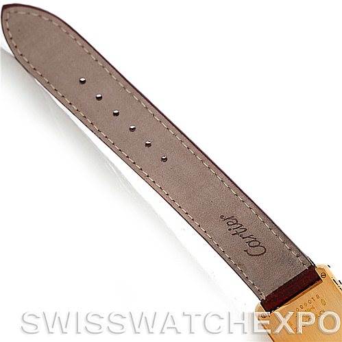 This image shows the brown leather strap of a Cartier Tank Classic Men's Yellow Gold Silver Dial Men's Yellow Gold Silver Dial watch from a top view, displaying the Cartier logo.