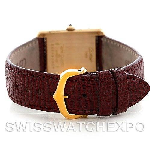 The image shows the back view of the Cartier Tank Classic Men's Yellow Gold Silver Dial Men's Yellow Gold Silver Dial watch, focusing on the leather strap and gold buckle.