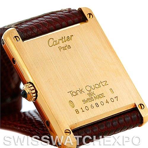 The image shows the back of a Cartier Tank Classic Men's Yellow Gold Silver Dial Men's Yellow Gold Silver Dial watch, highlighting the gold case and engraved details.