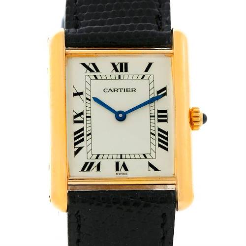 The image shows a close-up, front view of the Cartier Tank Classic Yellow Gold Beige Dial Yellow Gold Beige Dial watch face and part of its black leather strap.