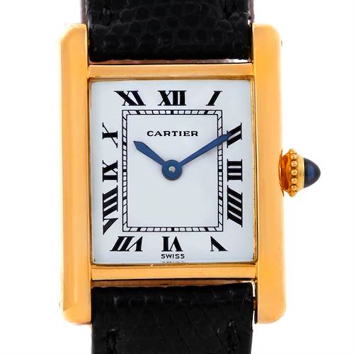 The image shows a Cartier Tank Classic Women's Yellow Gold White Dial Women's Yellow Gold White Dial watch front on, displaying its face, gold frame, and crown with a blue cabochon.