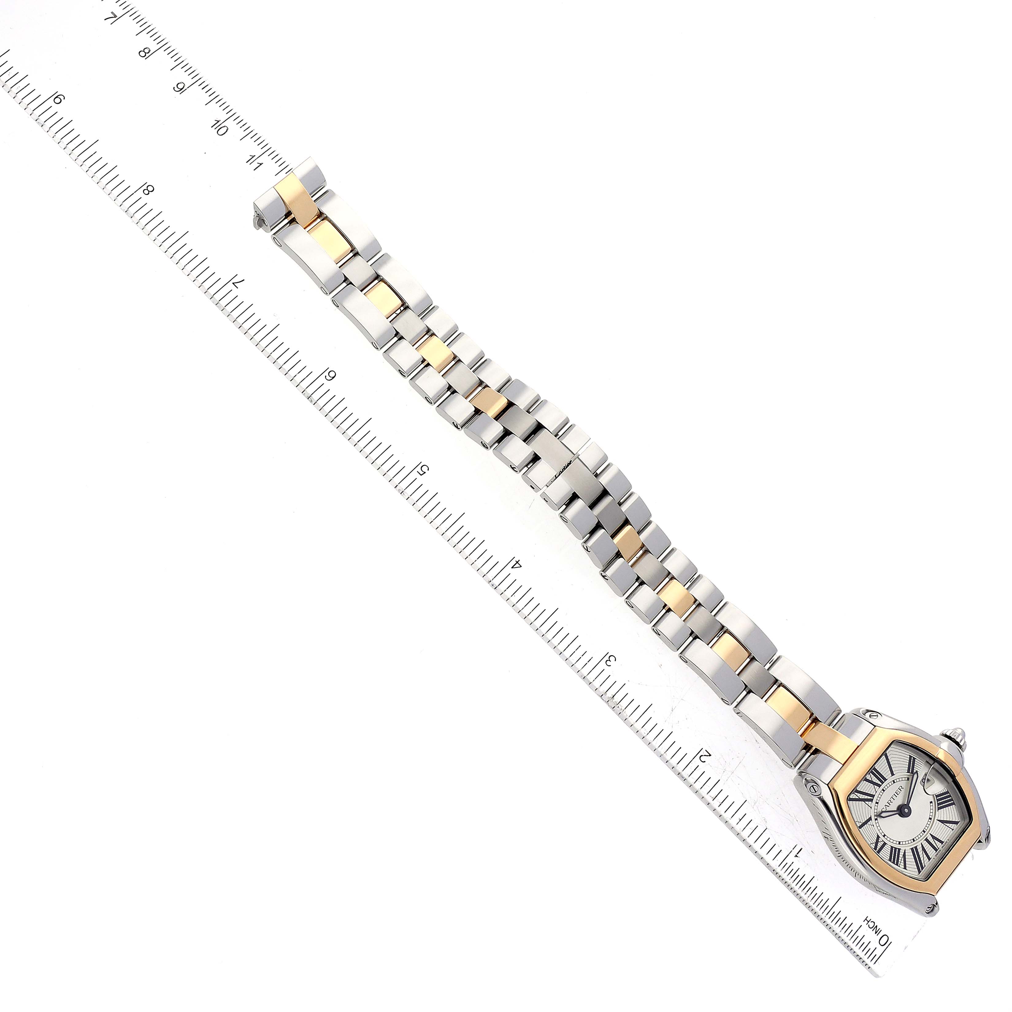 The Cartier Roadster W62026Y4 Women's Steel and Gold (two tone) Silver Dial W62026Y4 Women's Steel and Gold (two tone) Silver Dial watch is shown from a top-down angle, featuring its face and band next to a ruler for scale.