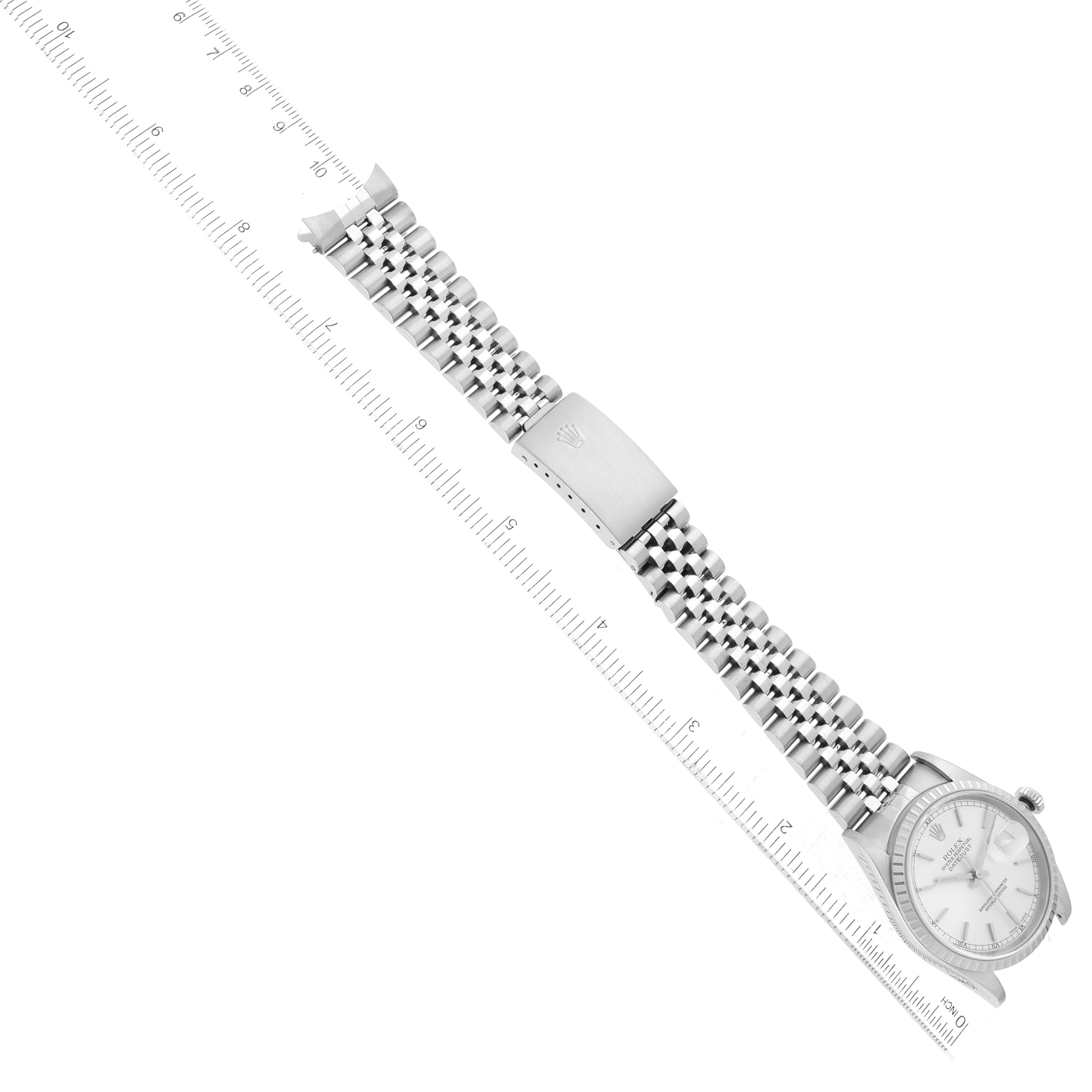 The image shows a Rolex Datejust 16220 Men's Stainless Steel Silver Dial 16220 Men's Stainless Steel Silver Dial watch at an oblique angle, highlighting the bracelet and clasp with a millimeter ruler for scale.