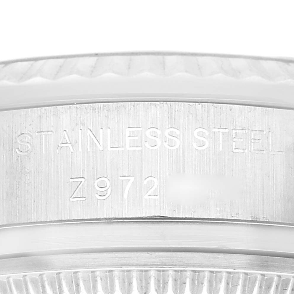 The image shows a close-up of the side of the stainless steel case of a Rolex Datejust 179174 Women's Stainless Steel Silver Dial 179174 Women's Stainless Steel Silver Dial watch, featuring engraved text.