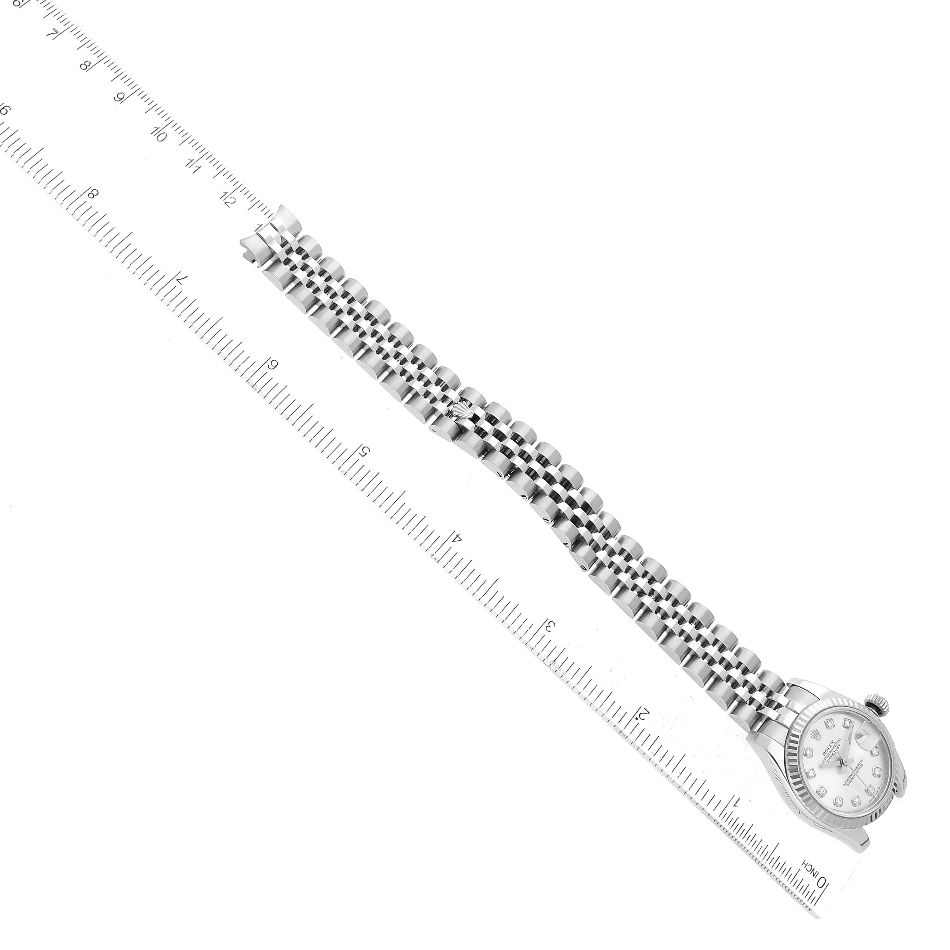The image shows a top-down view of a Rolex Datejust 179174 Women's Stainless Steel Silver Dial 179174 Women's Stainless Steel Silver Dial watch with its bracelet extended, placed alongside a ruler for scale.
