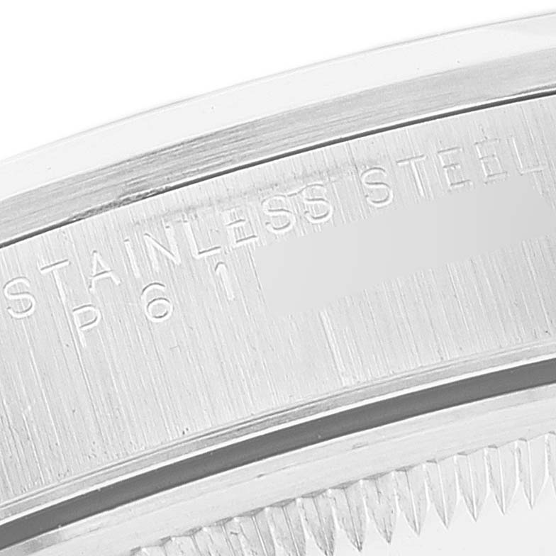 This image shows a close-up of the engraving on the stainless steel case of a Date model by Rolex.
