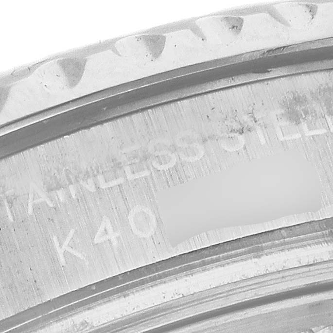 This close-up image of a Rolex Yacht-Master 169622 Women's Stainless Steel Silver Dial 169622 Women's Stainless Steel Silver Dial watch shows part of the stainless steel case with some engraved markings.