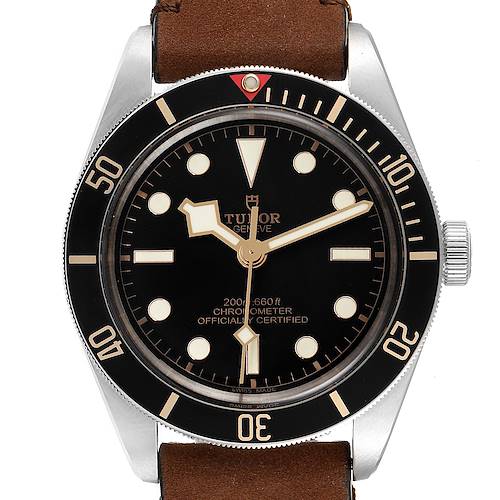 The Tudor Heritage Black Bay 79030N Men's Stainless Steel Black Dial 79030N Men's Stainless Steel Black Dial watch is shown from a front angle, displaying its dial, bezel, and part of the brown leather strap.