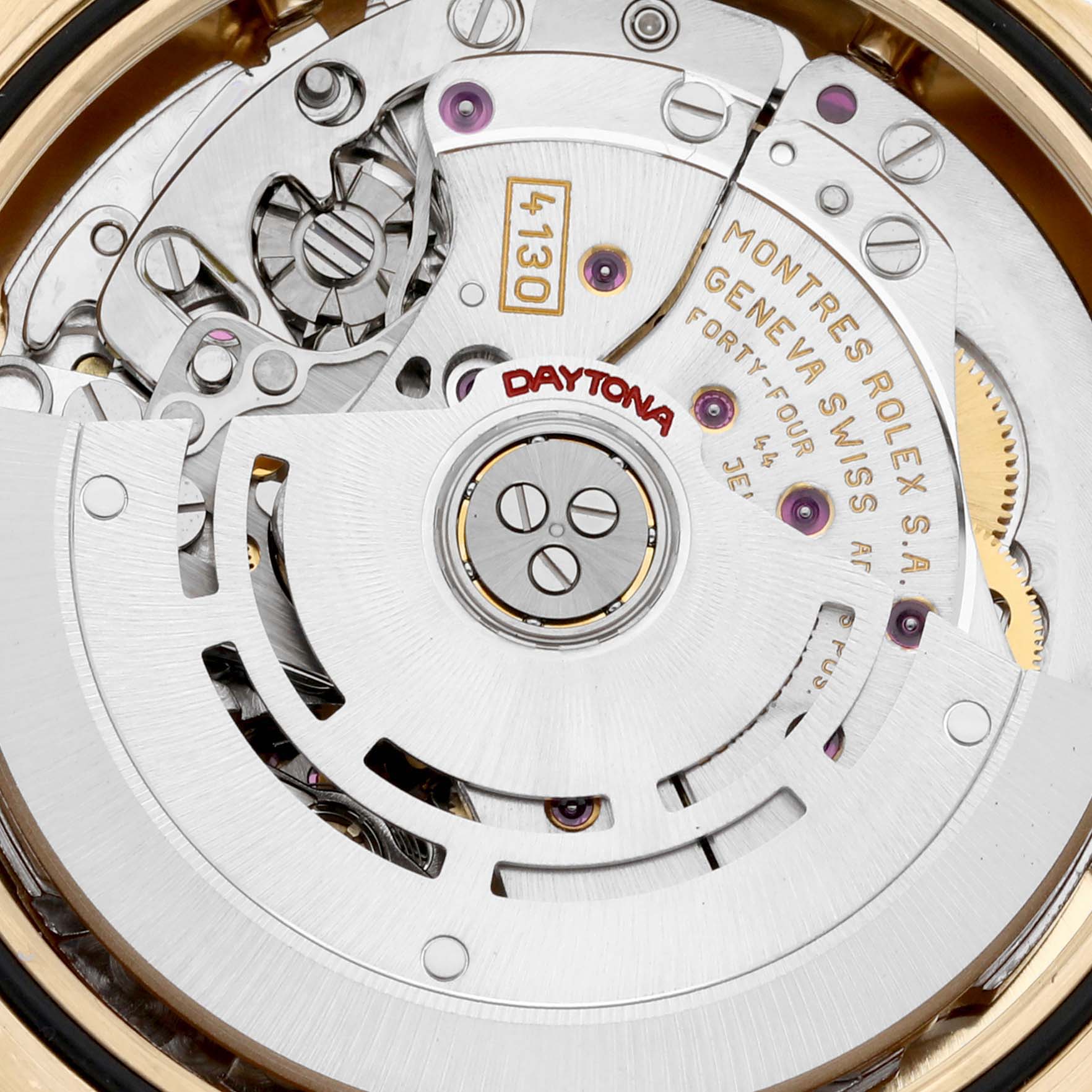 This close-up image shows the intricate internal mechanism of the Rolex Daytona 116528 Men's Yellow Gold Black Dial 116528 Men's Yellow Gold Black Dial watch, highlighting the movement parts and engravings.