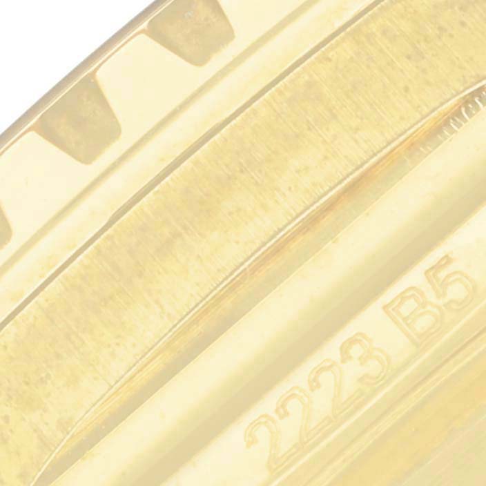 The image shows a close-up of the bezel and part of the case back of a Breitling Superocean N17375 Men's Yellow Gold Green Dial N17375 Men's Yellow Gold Green Dial watch, displaying some engraved numbers.