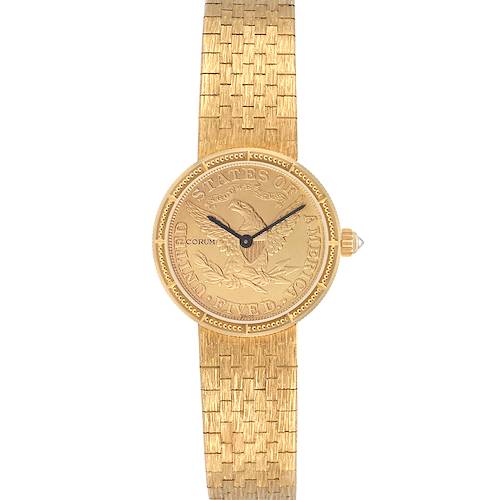 The Corum 1892 YEAR men's watch is shown from a top-down angle, highlighting its gold coin-style dial, textured bracelet, and crown.