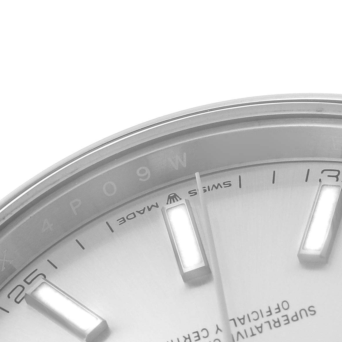 The image shows a close-up of the upper left section of the dial of a Rolex Datejust 41 126300 Men's Stainless Steel Silver Dial 126300 Men's Stainless Steel Silver Dial watch, displaying part of the hour markers and text.