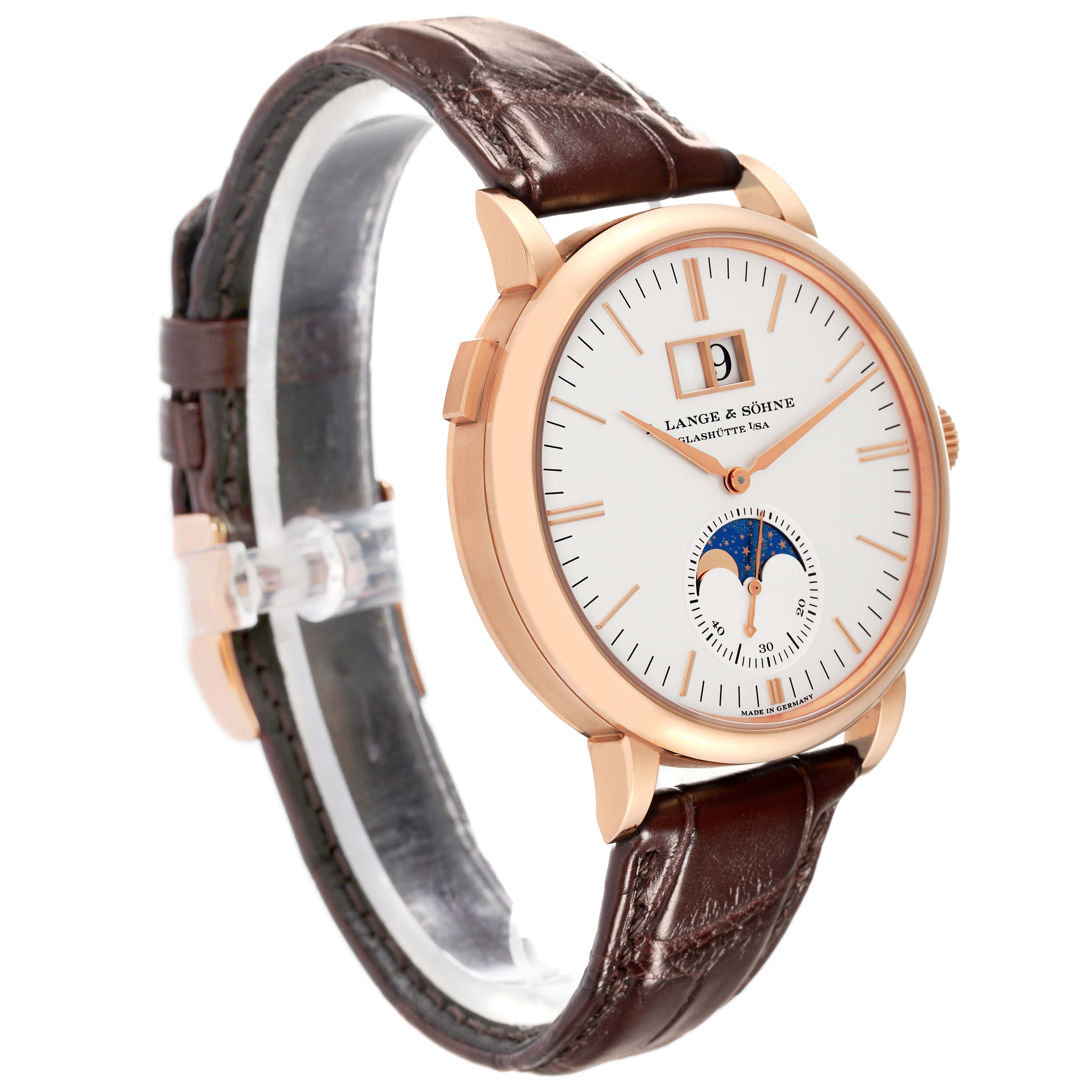 The image shows a side angle of the A. Lange & Sohne Saxonia 384.032 Men's Rose Gold Silver Dial watch with a brown leather strap, gold case, and moon phase dial.