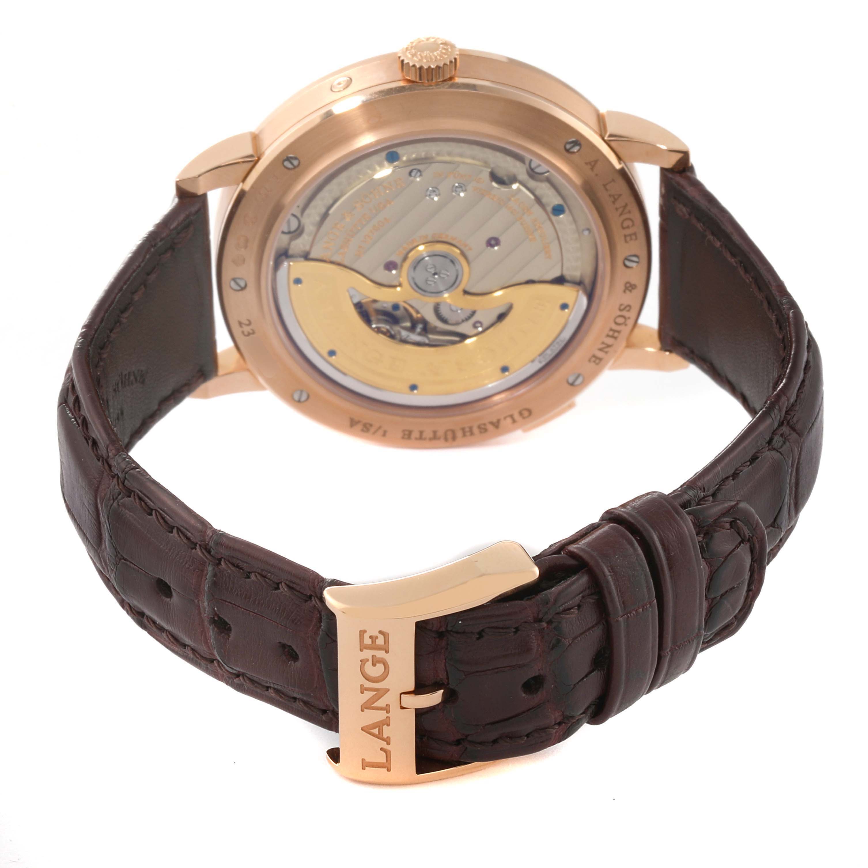 The image shows the back and clasp of the A. Lange & Sohne Saxonia 384.032 Men's Rose Gold Silver Dial watch, highlighting the movement and leather strap.