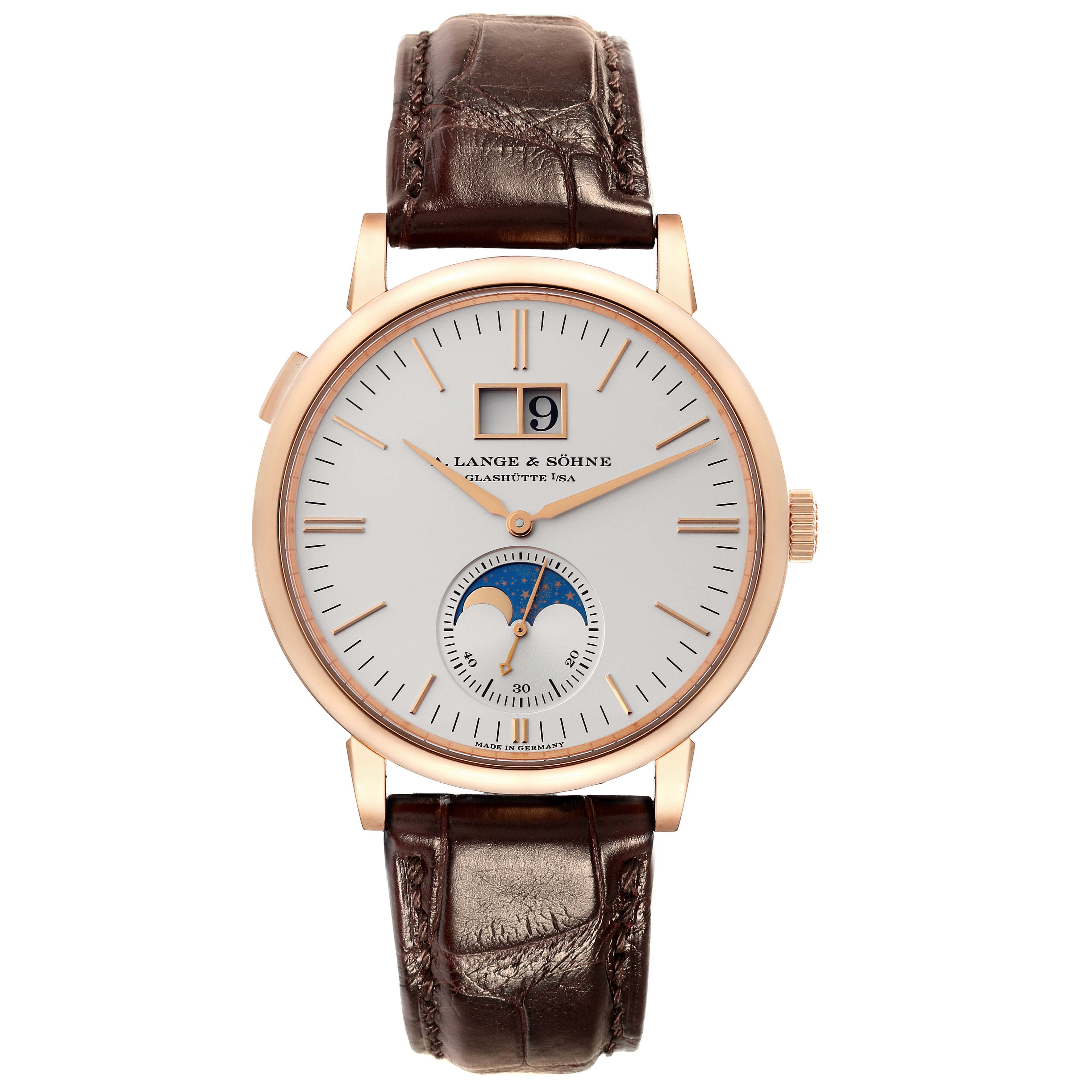 The image shows a front view of the Saxonia watch by A. Lange & Söhne, featuring its dial, moon phase subdial, and brown leather strap.