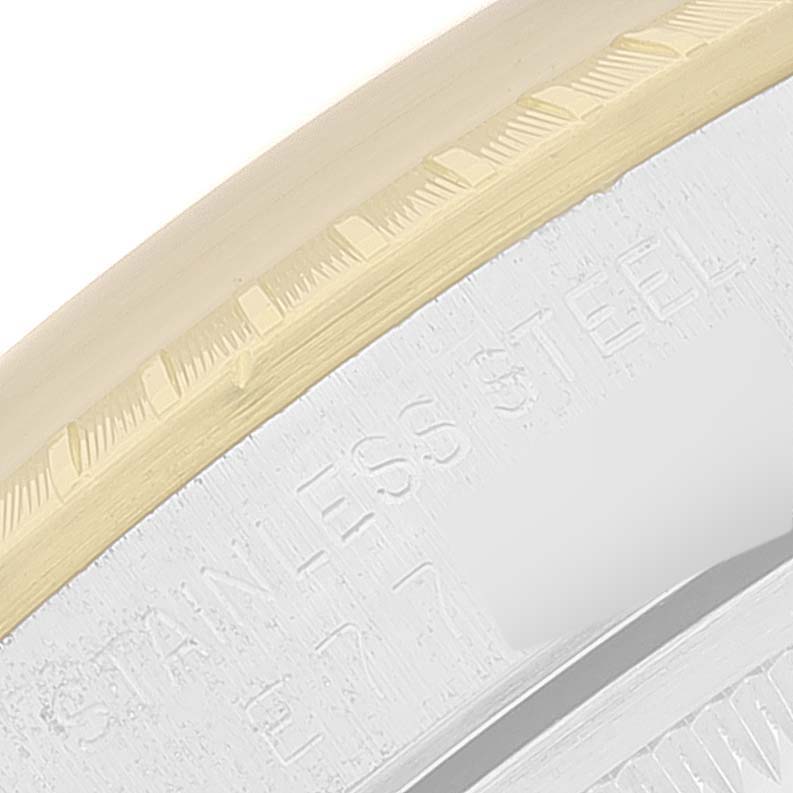 The close-up image shows the bezel and part of the case of a Rolex Date 15223 Men's Steel and Gold (two tone) Champagne Dial 15223 Men's Steel and Gold (two tone) Champagne Dial model, highlighting the "STAINLESS STEEL" engraving.