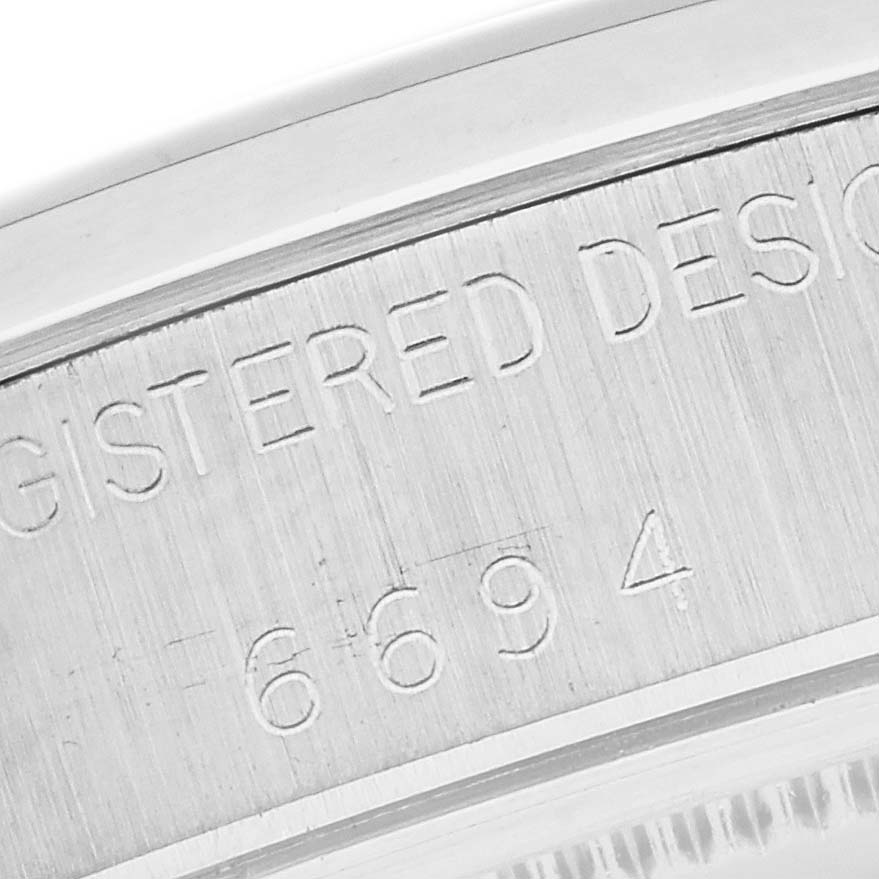 This close-up shot of the Rolex Vintage Collection 6694 Men's Stainless Steel Champagne Dial 6694 Men's Stainless Steel Champagne Dial model shows the engraved serial number on the watch case back.