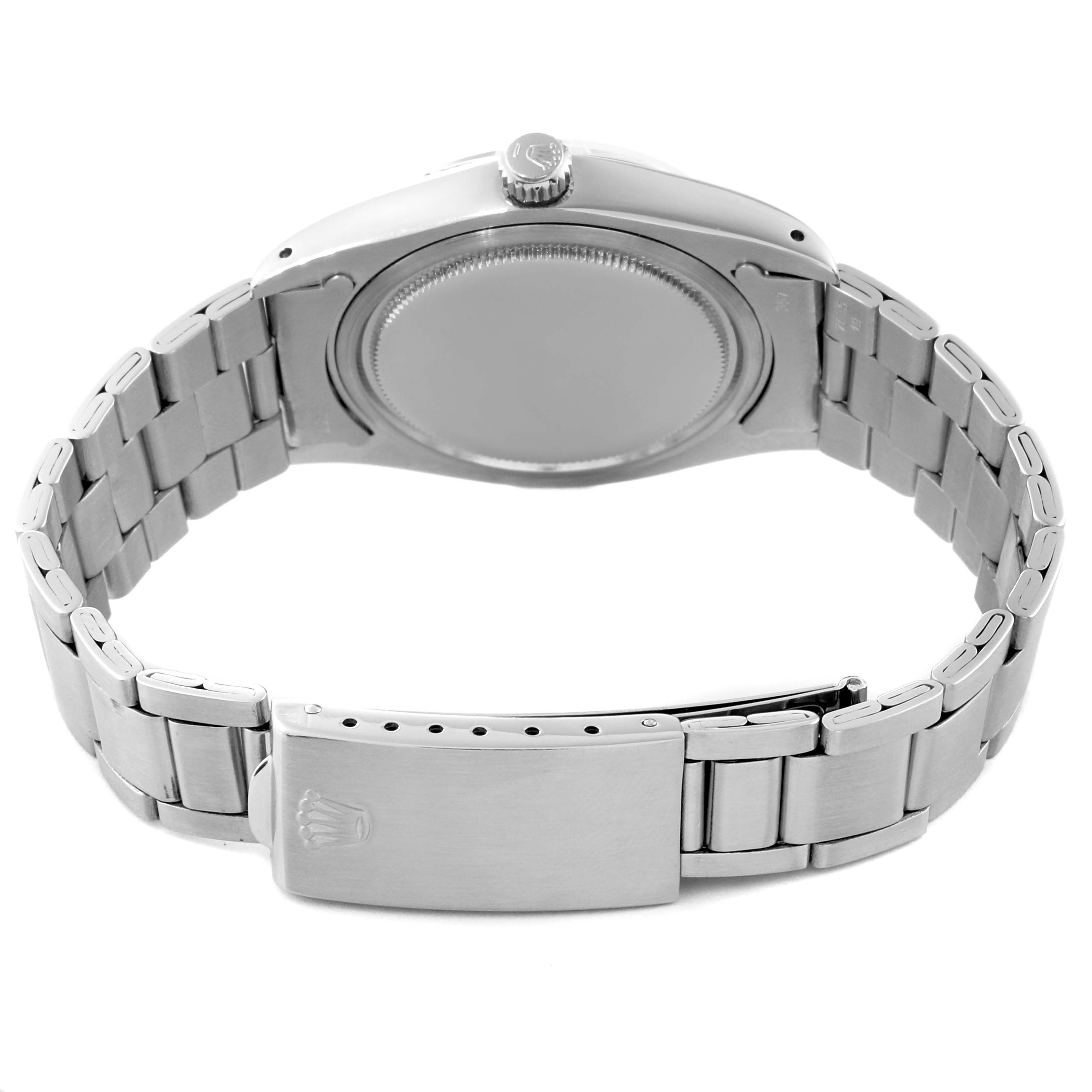 This image shows the back view of the Rolex Vintage Collection 6694 Men's Stainless Steel Champagne Dial 6694 Men's Stainless Steel Champagne Dial model, highlighting the case back, crown, and metal bracelet with the clasp.