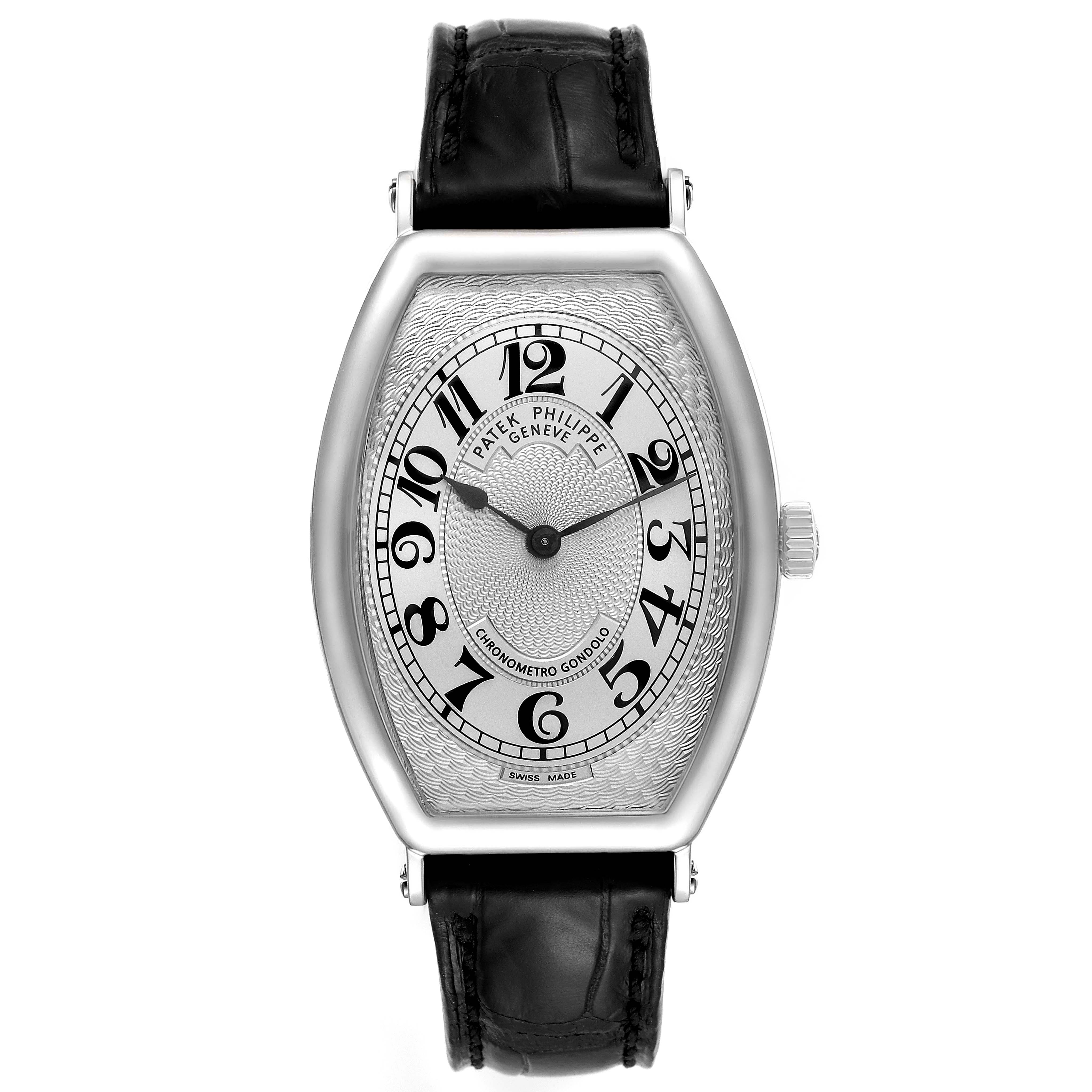 The image shows a front view of Patek Philippe's Gondolo model watch, featuring a black leather strap and Arabic numerals on its dial.