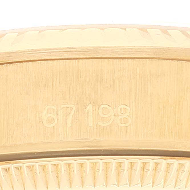 This image shows the side of a Rolex Pearlmaster 67198 Women's Yellow Gold Black Dial 67198 Women's Yellow Gold Black Dial watch, focusing on its model number engraved on the bezel.