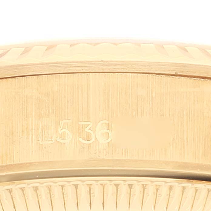 This image shows a close-up of the side engraving on the Rolex Pearlmaster 67198 Women's Yellow Gold Black Dial 67198 Women's Yellow Gold Black Dial watch's case.