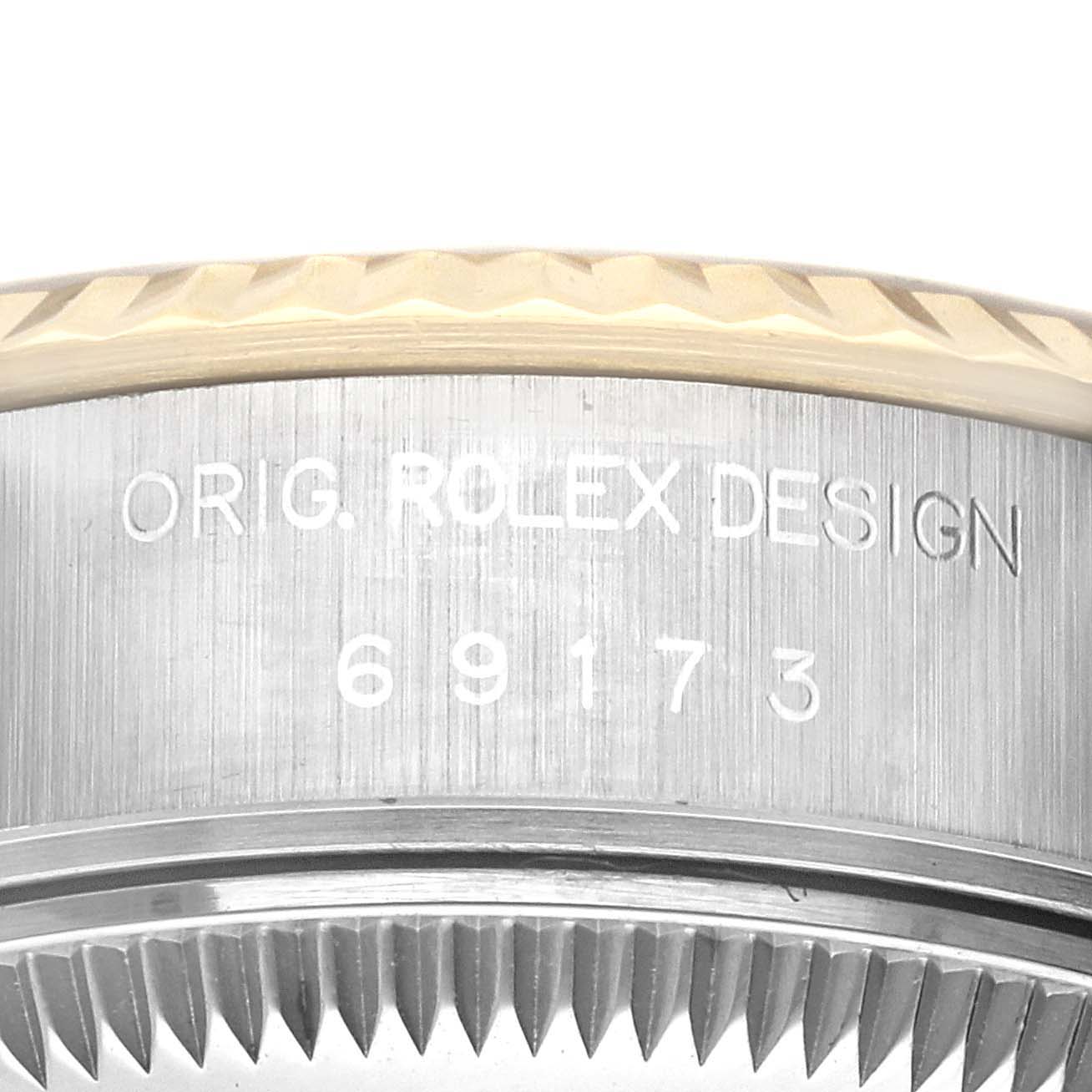 This image shows a close-up of the side of a Rolex Datejust 69173 Women's Steel and Gold (two tone) Champagne Dial 69173 Women's Steel and Gold (two tone) Champagne Dial watch, highlighting the engraved model number and "ORIG. ROLEX DESIGN" text.